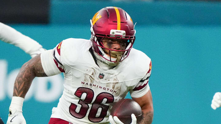 Nov 16, 2025; Madrid, Spain; Washington Commanders running back Chris Rodriguez Jr. (36) carries the ball against the Miami Dolphins in the second quarter during the 2025 NFL Madrid Game at Santiago Bernabeu Stadium. Mandatory Credit: Kirby Lee-Imagn Images