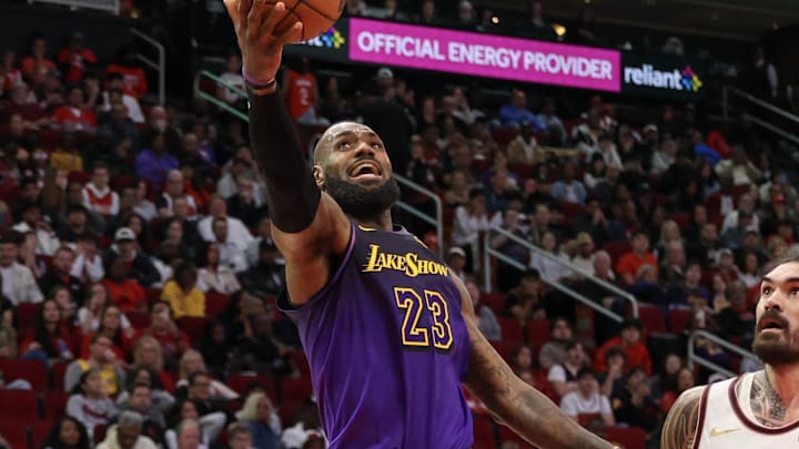 Jan 5, 2025; Houston, Texas, USA; Los Angeles Lakers forward LeBron James (23) drives to the basket against Houston Rockets center Steven Adams (12) in the fourth quarter at Toyota Center. Mandatory Credit: Thomas Shea-Imagn Images