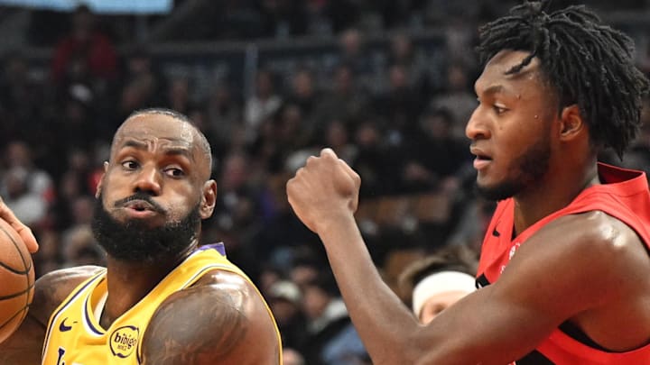 Los Angeles Lakers forward LeBron James drives to the basket between Toronto Raptors guard Immanuel Quickley. Los Angeles Lakers forward LeBron James drives to the basket between Toronto Raptors guard Immanuel Quickley.