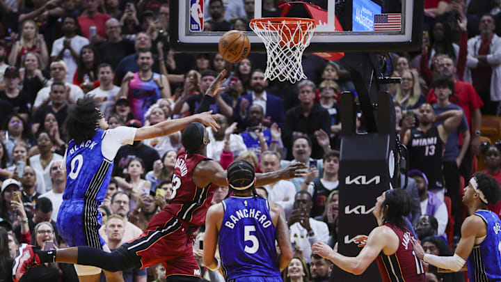 Jan 12, 2024; Miami, Florida, USA; Miami Heat center Bam Adebayo (13) drives to the basket ahead of Orlando Magic guard Anthony Black (0) and forward Paolo Banchero (5) during the fourth quarter at Kaseya Center. Mandatory Credit: Sam Navarro-Imagn Images Jan 12, 2024; Miami, Florida, USA; Miami Heat center Bam Adebayo (13) drives to the basket ahead of Orlando Magic guard Anthony Black (0) and forward Paolo Banchero (5) during the fourth quarter at Kaseya Center. Mandatory Credit: Sam Navarro-Imagn Images