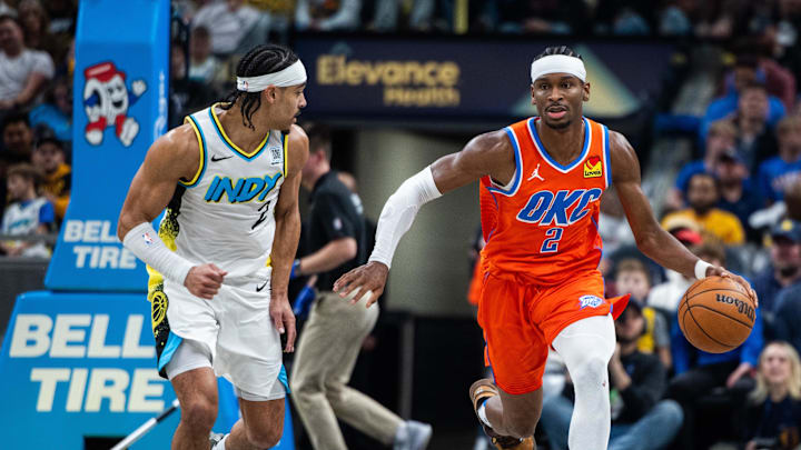 Dec 26, 2024; Indianapolis, Indiana, USA; Oklahoma City Thunder guard Shai Gilgeous-Alexander (2) dribbles the ball while  Indiana Pacers guard Andrew Nembhard (2) defends in the second half at Gainbridge Fieldhouse. Mandatory Credit: Trevor Ruszkowski-Imagn Images