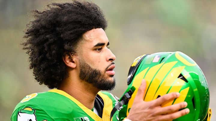 Dec 20, 2025; Eugene, OR, USA; Oregon Ducks quarterback Dante Moore (5) looks on before the game against the James Madison Dukes at Autzen Stadium. Mandatory Credit: Troy Wayrynen-Imagn Images