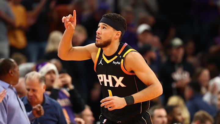 Phoenix Suns guard Devin Booker celebrates after scoring his 15,000th NBA point.