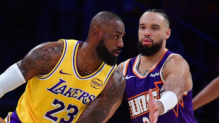 Dec 1, 2025; Los Angeles, California, USA; Los Angeles Lakers forward LeBron James (23) moves the ball against Phoenix Suns forward Dillon Brooks (3) during the first half at Crypto.com Arena. Mandatory Credit: Gary A. Vasquez-Imagn Images