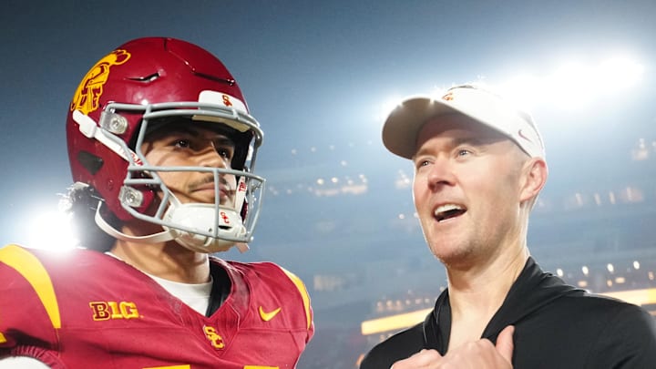 Nov 29, 2025; Los Angeles, California, USA; Southern California Trojans quarterback Jayden Maiava (14) and head coach Lincoln Riley react after the game against the UCLA Bruins at United Airlines Field at Los Angeles Memorial Coliseum. Mandatory Credit: Kirby Lee-Imagn Images
