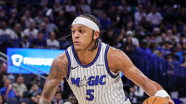 Orlando Magic forward Paolo Banchero moves the ball in front of New Orleans Pelicans center Derik Queen.