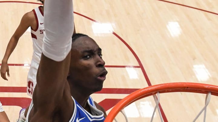 Jan 17, 2026; Stanford, California, USA; Duke Blue Devils guard Dame Sarr (7) dunks against Stanford Cardinal forward AJ Rohosy (4) in the first half at Maples Pavilion. Mandatory Credit: Eakin Howard-Imagn Images