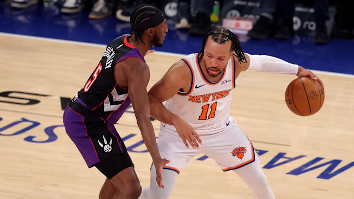 Jan 8, 2025; New York, New York, USA; New York Knicks guard Jalen Brunson (11) controls the ball against Toronto Raptors guard Immanuel Quickley (5) during the first quarter at Madison Square Garden. Mandatory Credit: Brad Penner-Imagn Images