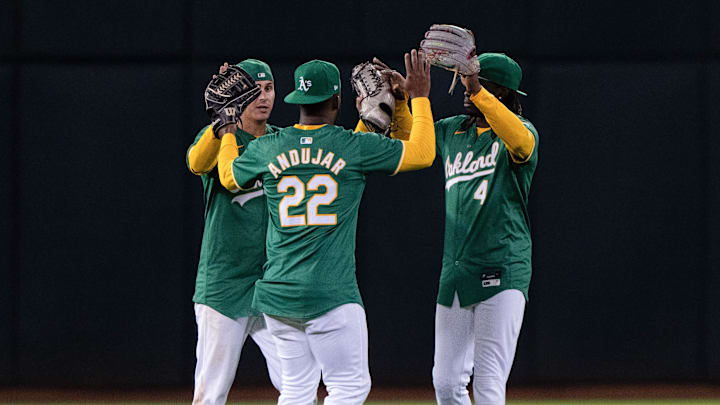 Aug 19, 2024; Oakland, California, USA; Oakland Athletics outfielders Abraham Toro (31) , Miguel Andujar (22) and Lawrence Butler (4) celebrate after defeating the Tampa Bay Rays at Oakland-Alameda County Coliseum. Mandatory Credit: Stan Szeto-Imagn Images