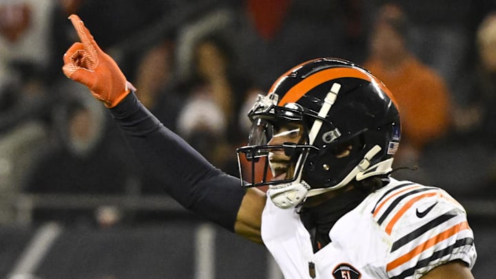 Chicago Bears cornerback Kyler Gordon points to his newly-overstuffed safety deposit box