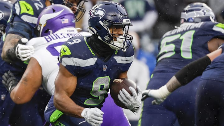Dec 22, 2024; Seattle, Washington, USA; Seattle Seahawks running back Kenneth Walker III (9) rushes against the Minnesota Vikings during the first quarter at Lumen Field. Mandatory Credit: Joe Nicholson-Imagn Images