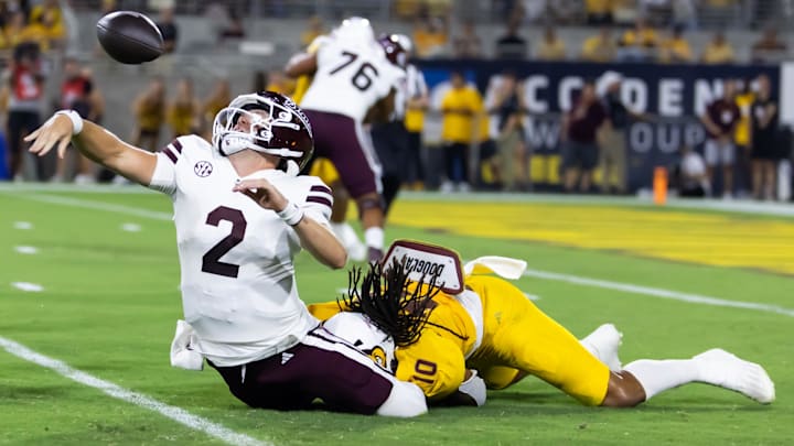 Mississippi State Bulldogs quarterback Blake Shapen (2) fumbles the ball as he is tackled by Arizona State Sun Devils defensive lineman Clayton Smith (10) in the first half at Mountain America Stadium.