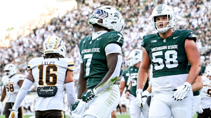 Michigan State's Brandon Tullis, left, celebrates his touchdown against Western Michigan during the first quarter on Friday, Aug. 29, 2025, in East Lansing.