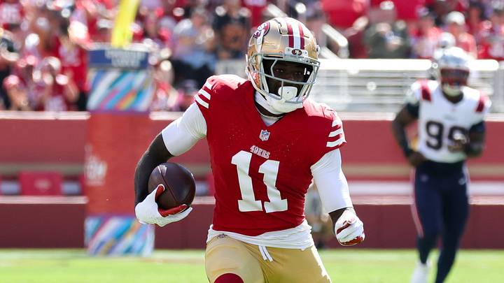 Sep 29, 2024; Santa Clara, California, USA; San Francisco 49ers wide receiver Brandon Aiyuk (11) runs with the ball past New England Patriots linebacker Jahlani Tavai (48) during the first quarter at Levi's Stadium. Mandatory Credit: Sergio Estrada-Imagn Images Sep 29, 2024; Santa Clara, California, USA; San Francisco 49ers wide receiver Brandon Aiyuk (11) runs with the ball past New England Patriots linebacker Jahlani Tavai (48) during the first quarter at Levi's Stadium. Mandatory Credit: Sergio Estrada-Imagn Images