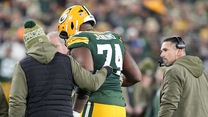 Green Bay Packers guard Elgton Jenkins (74) comes off the file with an apparent injury against the Green Bay Packers in the first half at Lambeau Field.