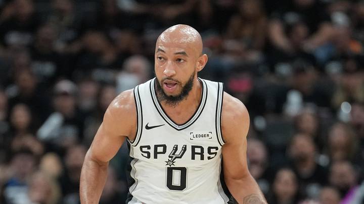 May 6, 2026; San Antonio, Texas, USA; San Antonio Spurs guard Jordan McLaughlin (0) dribbles next to Minnesota Timberwolves guard Jaylen Clark (22) in the second half during game two of the second round of the 2026 NBA Playoffs at Frost Bank Center. Mandatory Credit: Daniel Dunn-Imagn Images