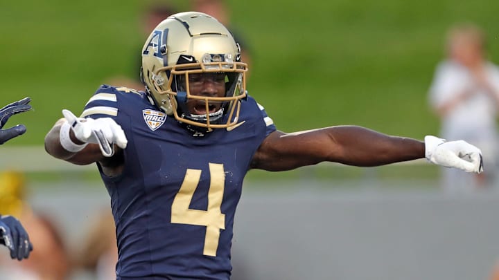 Akron Zips wide receiver Bobby Golden, right, celebrates his first-half touchdown catch against Colgate, Saturday, Sept. 14, 2024.