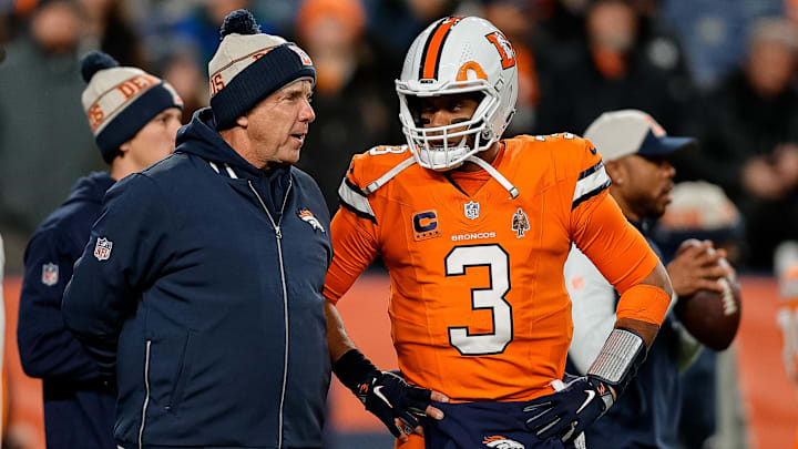Dec 24, 2023; Denver, Colorado, USA; Denver Broncos head coach Sean Payton talks with quarterback Russell Wilson (3) before the game against the New England Patriots at Empower Field at Mile High.
