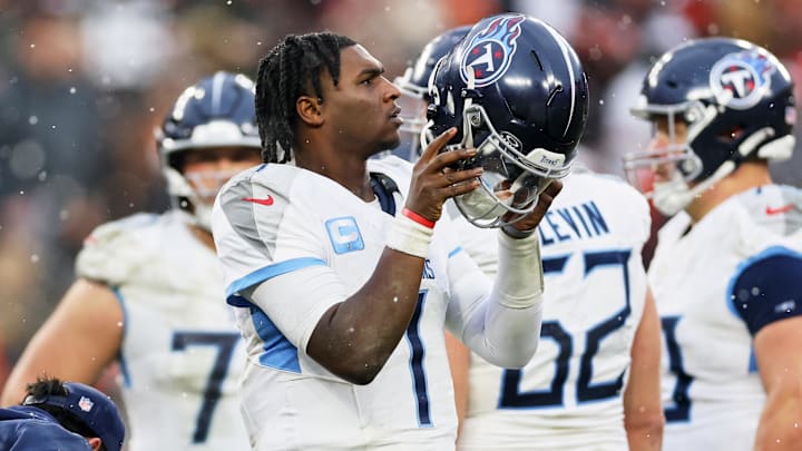 Dec 7, 2025; Cleveland, Ohio, USA; Tennessee Titans quarterback Cam Ward (1) holds his helmet on the sideline against the Cleveland Browns during the third quarter at Huntington Bank Field. Mandatory Credit: Scott Galvin-Imagn Images