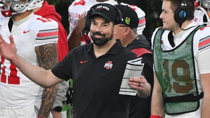Jan 1, 2025; Pasadena, CA, USA; Ohio State Buckeyes head coach Ryan Day tries to get the attention of his players on the field during the fourth quarter against the Oregon Ducks at Rose Bowl Stadium. Mandatory Credit: Robert Hanashiro-Imagn Images