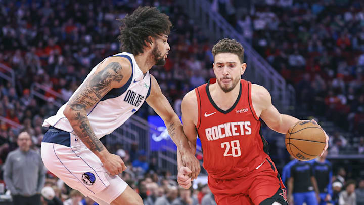 Jan 1, 2025; Houston, Texas, USA; Houston Rockets center Alperen Sengun (28) drives with the ball as Dallas Mavericks center Dereck Lively II (2) defends during the first quarter at Toyota Center. Mandatory Credit: Troy Taormina-Imagn Images