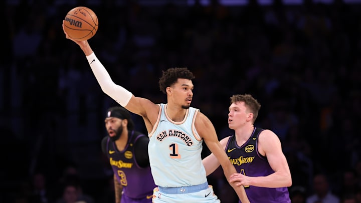 Jan 13, 2025; Los Angeles, California, USA; San Antonio Spurs center Victor Wembanyama (1) posts up against Los Angeles Lakers guard Dalton Knecht (4) during the second quarter at Crypto.com Arena.