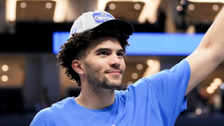 Mar 14, 2026; Charlotte, NC, USA; Duke Blue Devils forward Cameron Boozer (12) cuts down the net after defeating the Virginia Cavaliers in the men's ACC Conference Tournament Championship at Spectrum Center. Mandatory Credit: Bob Donnan-Imagn Images Mar 14, 2026; Charlotte, NC, USA; Duke Blue Devils forward Cameron Boozer (12) cuts down the net after defeating the Virginia Cavaliers in the men's ACC Conference Tournament Championship at Spectrum Center. Mandatory Credit: Bob Donnan-Imagn Images