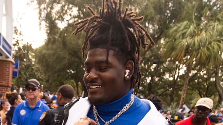 Florida Gators defensive lineman D'Antre Robinson (35) gets his jewelry adjusted by a fan during Gator Walk before the start of the game against the UCF Knights at Ben Hill Griffin Stadium in Gainesville, FL on Saturday, October 5, 2024. [Doug Engle/Gainesville Sun]