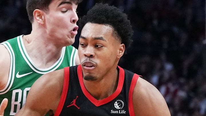 Toronto Raptors forward Scottie Barnes controls the ball as Boston Celtics guard Hugo Gonzalez tries to defend.