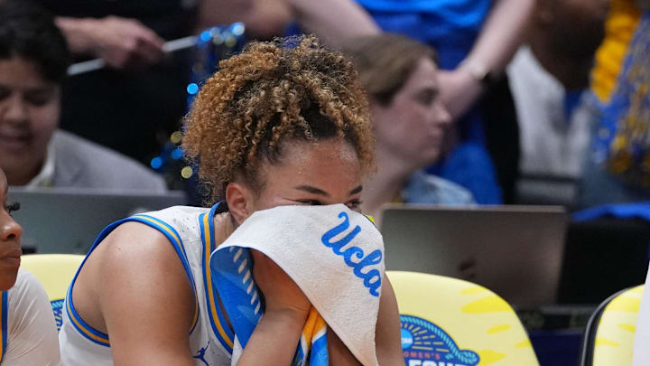 Apr 4, 2025; Tampa, FL, USA; UCLA Bruins center Lauren Betts (center) reacts on the bench during the fourth quarter in a semifinal of the women's 2025 NCAA tournament against the Connecticut Huskies at Amalie Arena. Mandatory Credit: Kirby Lee-Imagn Images Apr 4, 2025; Tampa, FL, USA; UCLA Bruins center Lauren Betts (center) reacts on the bench during the fourth quarter in a semifinal of the women's 2025 NCAA tournament against the Connecticut Huskies at Amalie Arena. Mandatory Credit: Kirby Lee-Imagn Images