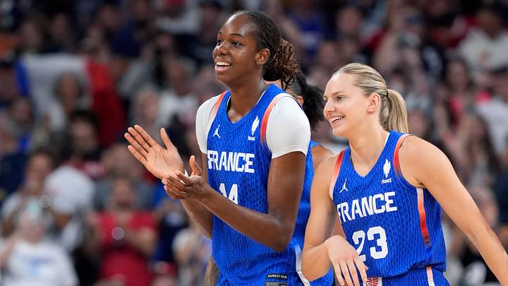Jul 29, 2024; Villeneuve-d'Ascq, France; France center Dominique Malonga (14) and guard Marine Johannes (23) celebrate after defeating Canada during the Paris 2024 Olympic Summer Games at Stade Pierre-Mauroy. Mandatory Credit: John David Mercer-USA TODAY Sports