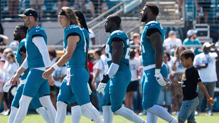Jacksonville Jaguars Jacksonville Jaguars punter Logan Cooke (9), Jacksonville Jaguars quarterback Trevor Lawrence (16), Jacksonville Jaguars linebacker Foye Oluokun (23) and defensive end Josh Hines-Allen walks with his son Wesley, 8, right, a cancer survivor, in tow as they walk on the field. Wesley was the honorary captain for Sunday’s game against the Seattle Seahawks in an NFL football game at EverBank Stadium, Sunday, Oct. 12, 2025, in Jacksonville, Fla. [Doug Engle/Florida Times-Union]