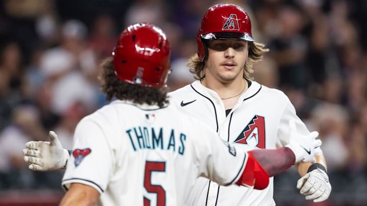 Aug 19, 2025; Phoenix, Arizona, USA; Arizona Diamondbacks outfielder Jake McCarthy (right) celebrates with teammate Alek Thomas after hitting a solo home run in the third inning against the Cleveland Guardians at Chase Field. Mandatory Credit: Mark J. Rebilas-Imagn Images
