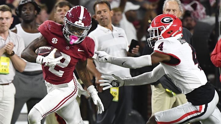 Sep 28, 2024; Tuscaloosa, Alabama, USA; Alabama Crimson Tide wide receiver Ryan Williams (2) breaks a tackle by Georgia Bulldogs defensive back KJ Bolden (4) to score a touchdown that put Alabama ahead in the fourth quarter at Bryant-Denny Stadium. Alabama defeated Georgia 41-34. Mandatory Credit: Gary Cosby Jr.-Imagn Images Sep 28, 2024; Tuscaloosa, Alabama, USA; Alabama Crimson Tide wide receiver Ryan Williams (2) breaks a tackle by Georgia Bulldogs defensive back KJ Bolden (4) to score a touchdown that put Alabama ahead in the fourth quarter at Bryant-Denny Stadium. Alabama defeated Georgia 41-34. Mandatory Credit: Gary Cosby Jr.-Imagn Images
