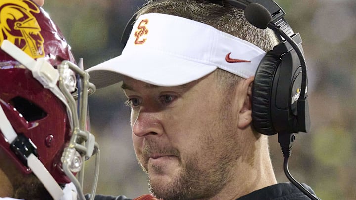 Nov 11, 2023; Eugene, Oregon, USA; USC Trojans head coach Lincoln Riley talks to quarterback Caleb Williams (13) during the first half against the Oregon Ducks at Autzen Stadium.  