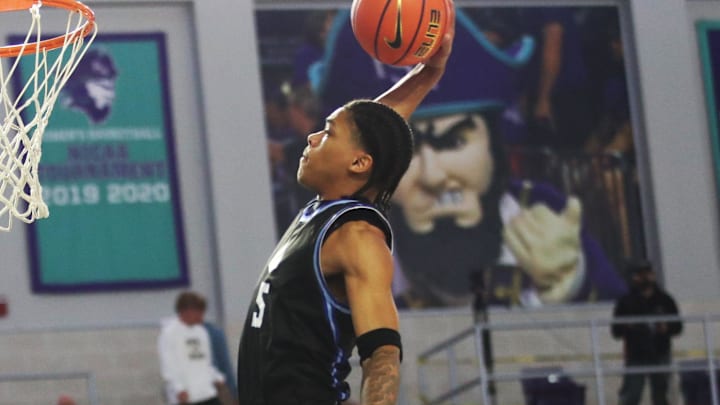 Darius Acuff Jr. from IMG Academy dunks against Oak Ridge during the third place game at the City of Palms Classic at Suncoast Credit Union Arena in Fort Myers on Monday, Dec. 23, 2024. IMG won.