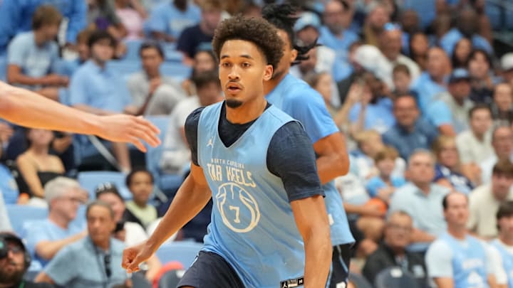 Oct 4, 2025; Charlotte, NC, USA; North Carolina Tar Heels guard Seth Trimble (7) on the fast break as guard Kyan Evans (0) defends in the second half at Dean E. Smith Center. Mandatory Credit: Bob Donnan-Imagn Images