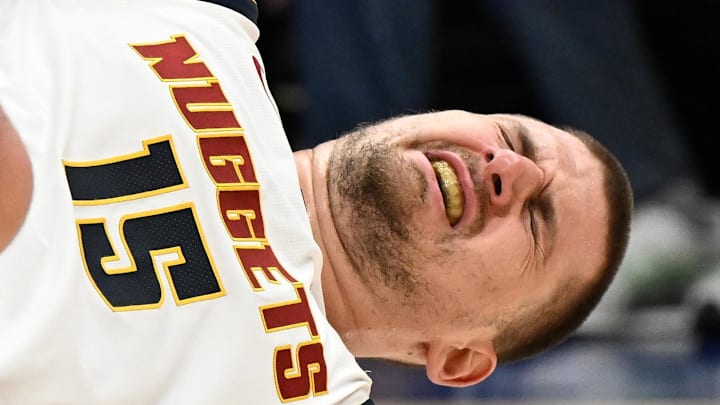 Feb 3, 2026; Detroit, Michigan, USA; Denver Nuggets center Nikola Jokic (15) reacts after being injured against the Detroit Pistons in the third quarter at Little Caesars Arena. Mandatory Credit: Lon Horwedel-Imagn Images