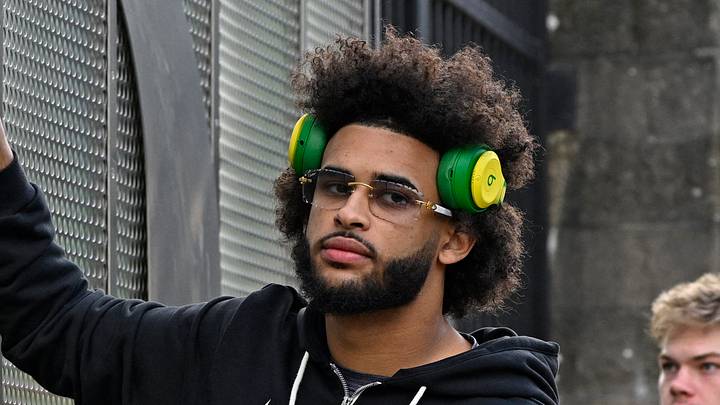 Nov 22, 2025; Eugene, Oregon, USA; Oregon Ducks quarterback Dante Moore (5) touches medal O during the march march before the game against the Southern California Trojans at Autzen Stadium. Nov 22, 2025; Eugene, Oregon, USA; Oregon Ducks quarterback Dante Moore (5) touches medal O during the march march before the game against the Southern California Trojans at Autzen Stadium.