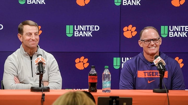 Clemson football head coach Dabo Swinney, left, and newly hired football defensive coordinator Tom Allen, formerly at Penn State University, speak with media in the Smart Family Media Center at Clemson University. 