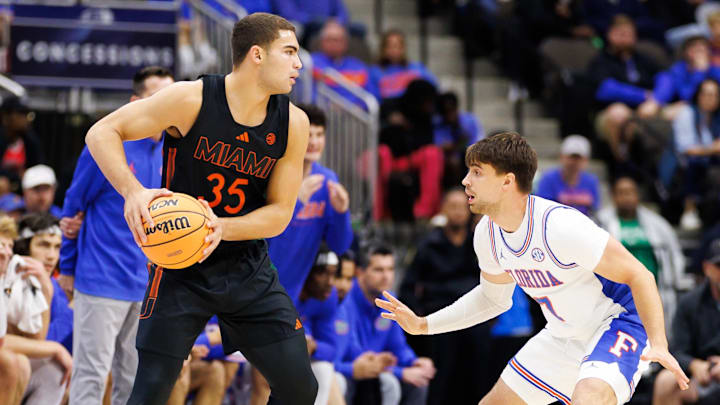 Nov 16, 2025; Gainesville, Florida, USA; Miami Hurricanes guard Dante Allen (35) looks to pass while Florida Gators guard Urban Klavzar (7) defends during the first half at VyStar Veterans Memorial Arena. Mandatory Credit: Matt Pendleton-Imagn Images
