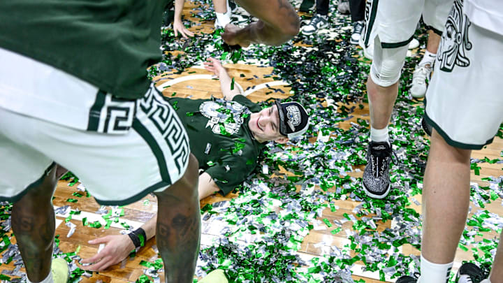Michigan State's Carson Cooper does a confetti angel while celebrating the Spartans Big Ten championship after the game against Michigan on Sunday, March 9, 2025, at the Breslin Center in East Lansing. Michigan State's Carson Cooper does a confetti angel while celebrating the Spartans Big Ten championship after the game against Michigan on Sunday, March 9, 2025, at the Breslin Center in East Lansing.