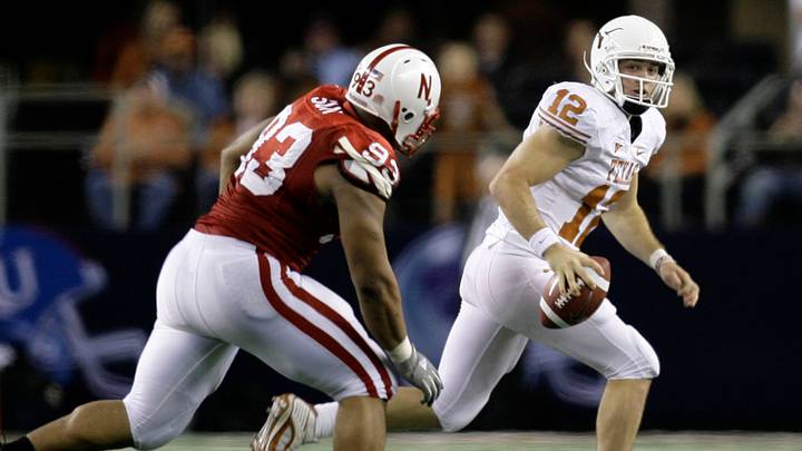 Dec 5, 2009; Arlington, TX, USA; Texas Longhorns quarterback Colt McCoy avoids the rush of Nebraska Cornhuskers defensive tackle Ndamukong Suh.