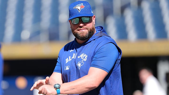 Jul 21, 2025; Toronto, Ontario, CAN; Toronto Blue Jays manager John Schneider (14) walks onto the field during practice before a game against the New York Yankees at Rogers Centre. 