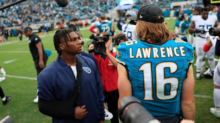 Jacksonville Jaguars quarterback Trevor Lawrence (16) greets Tennessee Titans quarterback Cam Ward (1), left, who was injured in the first quarter, after the game of an NFL football matchup at EverBank Stadium, Sunday, Jan. 4, 2026, in Jacksonville, Fla. The Jaguars defeated the Titans 41-7, capturing the AFC North title. [Corey Perrine/Florida Times-Union]