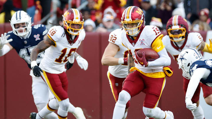 Dec 25, 2025; Landover, Maryland, USA; Washington Commanders wide receiver Chris Moore (19) carries the ball after a reception against the Dallas Cowboys in the third quarter at Northwest Stadium. Mandatory Credit: Amber Searls-Imagn Images