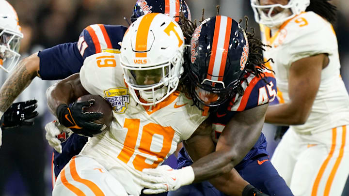 Tennessee running back Daune Morris (19) is stopped by Illinois linebacker Malachi Hood (45) on a kickoff return in the first quarter of the Music City Bowl NCAA college football game on Dec. 30, 2025, in Nashville, Tennessee.