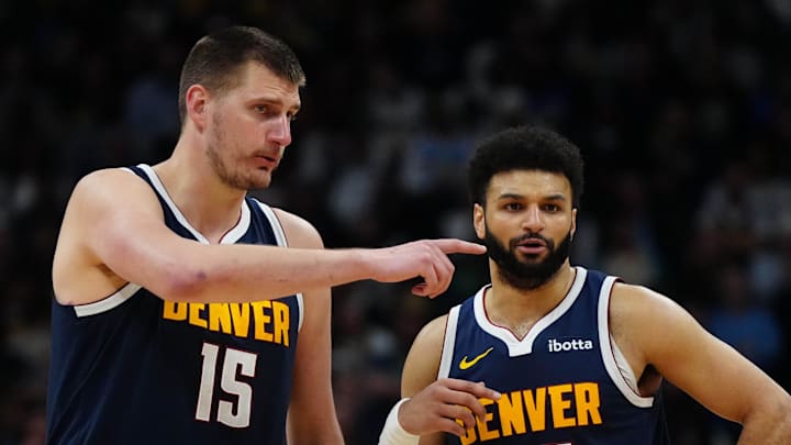 Apr 10, 2024; Denver, Colorado, USA; Denver Nuggets center Nikola Jokic (15) and guard Jamal Murray (27) talk in the fourth quarter against the Minnesota Timberwolves at Ball Arena. Mandatory Credit: Ron Chenoy-Imagn Images