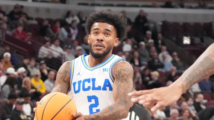 Mar 12, 2026; Chicago, IL, USA; Rutgers Scarlet Knights guard Jamichael Davis (1) defends UCLA Bruins guard Donovan Dent (2) during the first half at United Center. Mandatory Credit: David Banks-Imagn Images
