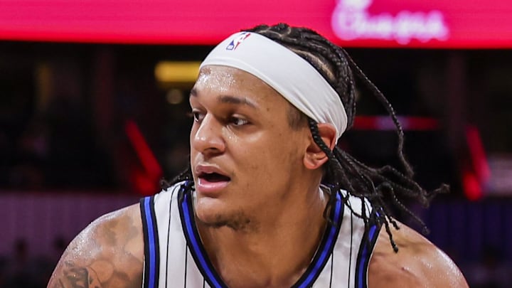 Orlando Magic forward Paolo Banchero drives against Milwaukee Bucks guard AJ Green.